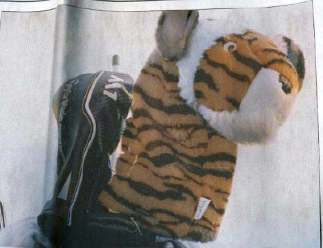 A vintage magazine photo of Donald Trump's golf bag featuring his tiger headcover from the early 2000s