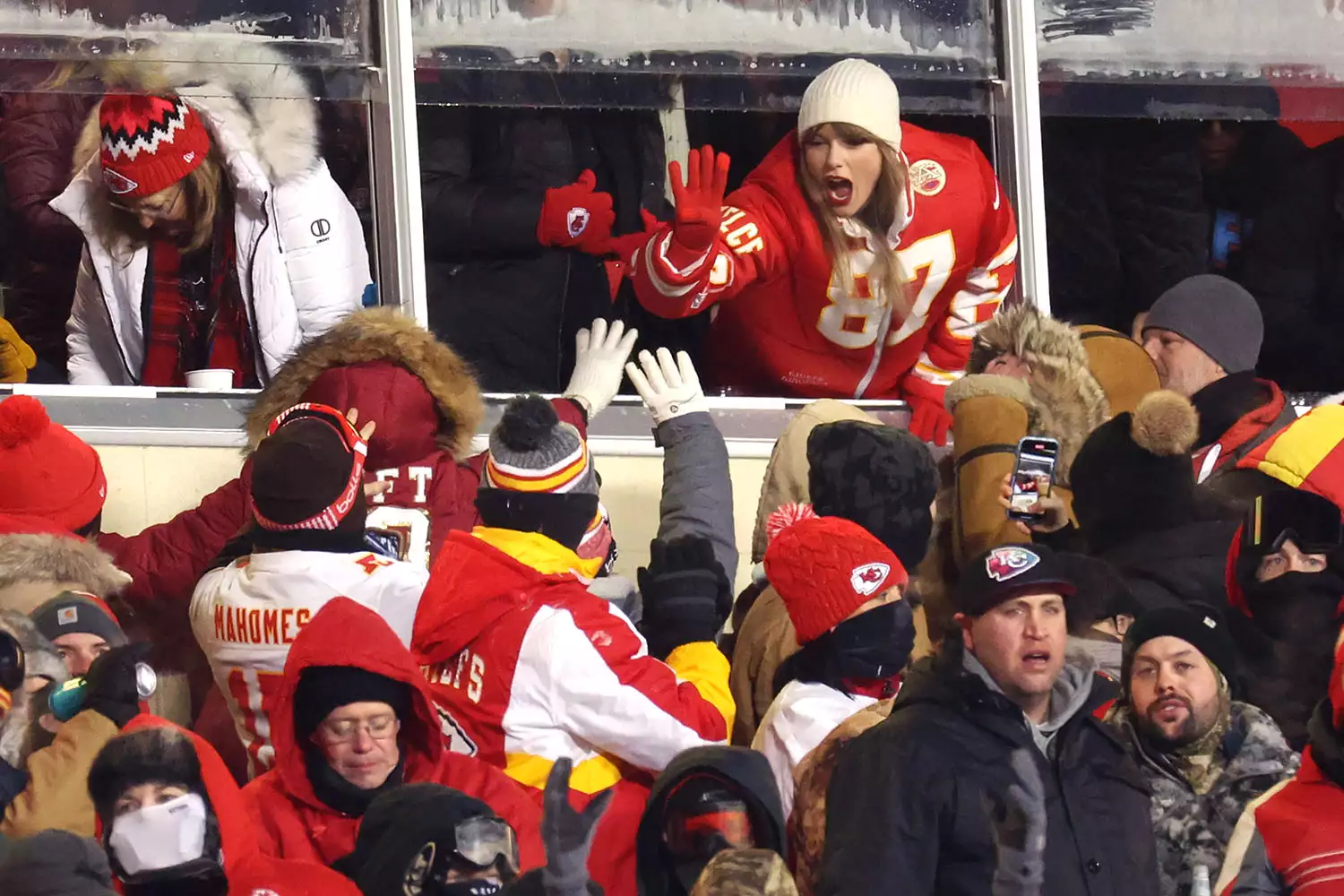 Taylor Swift celebrating during the Chiefs' playoff game in January 2024.